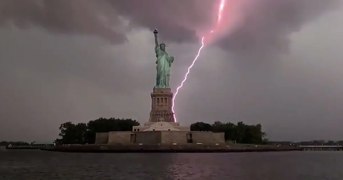 Lightning strikes the Statue of Liberty. A Breathtaking Moment Amidst Turmoil